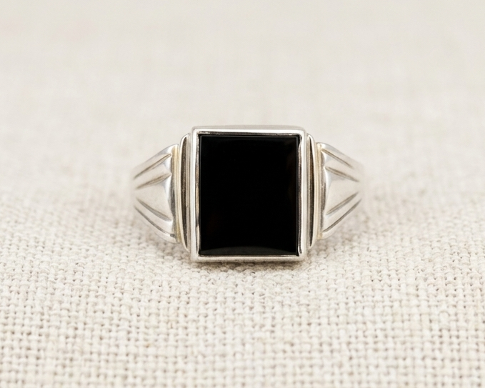Rectangular black onyx signet ring in sterling silver with geometric grooved detailing on the band